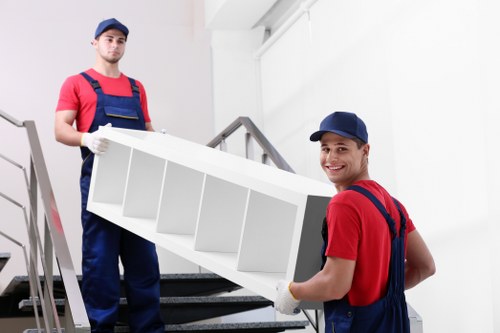 Furniture collection team handling bulky items in a Finchley home