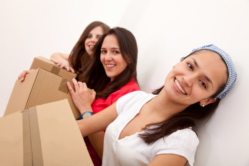 Removals crew handling furniture in a Finchley residential street