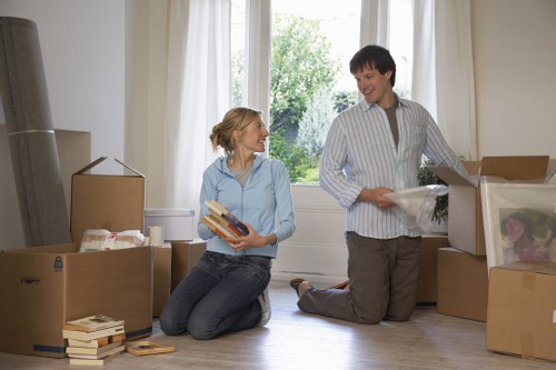 Professional movers handling furniture in a Finchley flat move